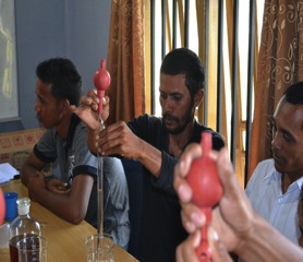 Cooperative members trying to measure the patchouli oil quality