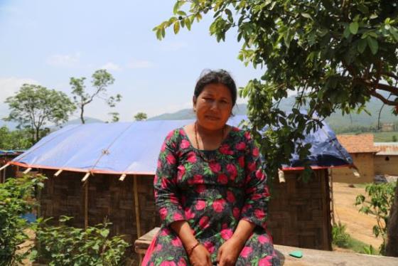 Sharmila Mejar in front of new temporary house (photo: Caritas Australia).