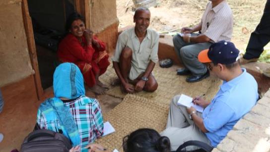 Mr Timlal with wife speaking with Manindra Malla Caritas Australia (photo: Caritas Nepal).