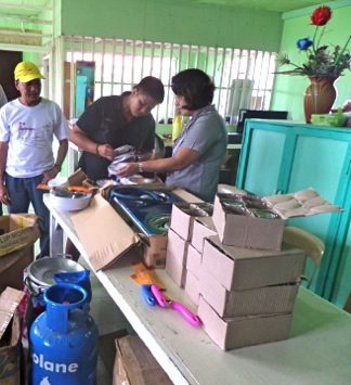 Teachers from high school in Basey controlling supplied kitchen equipment.