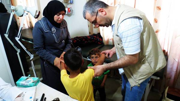 Dr. Joseph Homsi with Nour Al Hlwa and her children, Abdel Rahmanem a Yamenem