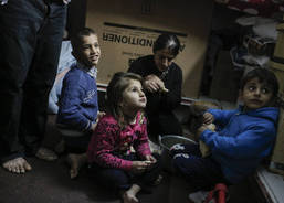 A family living in a container eat lunch