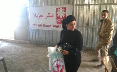 Žena odnášející svůj balíček čisticích prostředků.