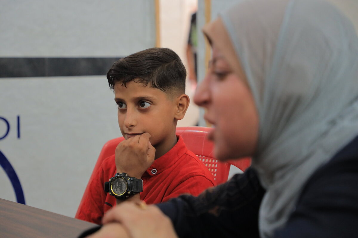 Aida and her son during a session at the clinic of Charity Jerusalem Aida and her son during a session at the clinic of Charity Jerusalem