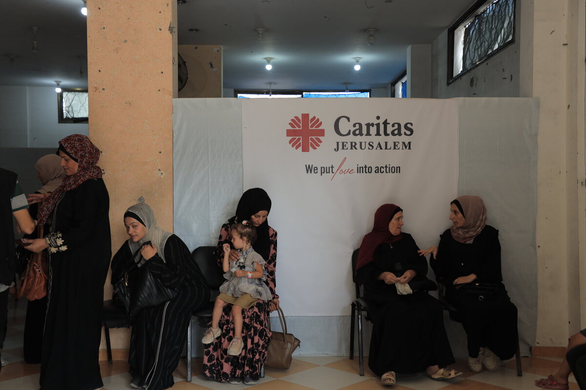 Women with children are waiting at the clinic of Caritas Jerusalem Women with children are waiting at the clinic of Caritas Jerusalem